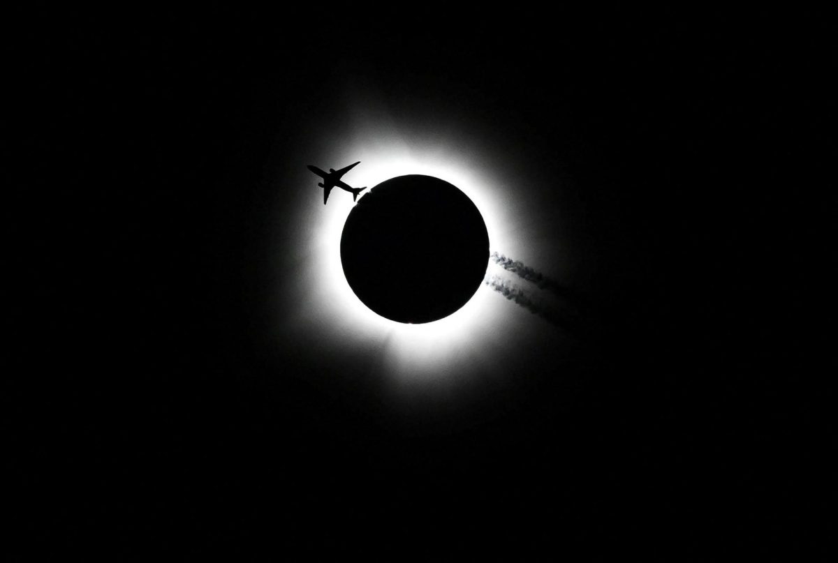 An airplane passes by as the total solar eclipse is seen from Bloomington, Indiana, on Monday, April 8. Bobby Goddin/USA Today Network/Reuters