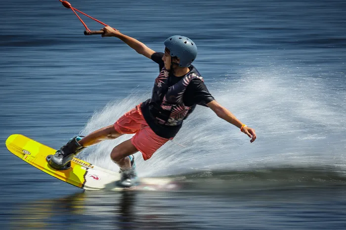 Caden Beese, Naples, carves through water on a wake board during a session at Shark Wake Park in Okeeheelee Park in unincorporated Palm Beach County, Fla., on June 28, 2023.