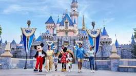 A family poses with iconic Disney characters in front of Cinderella's Palace. 