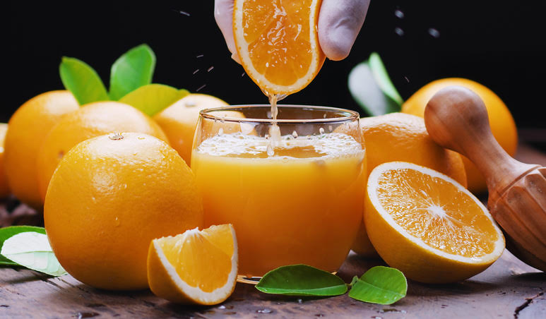 In the picture shown above it shows a delicious, fresh, and beautiful orange getting freshly squeezed.